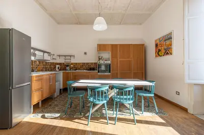 a kitchen with a table and chairs and a refrigerator at Carlo Apartment with Terrace by Wonderful Italy in Palermo