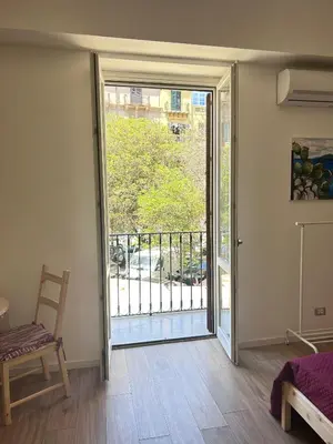 a room with a sliding glass door with a balcony at Dimora dell'Olivella 1 in Palermo