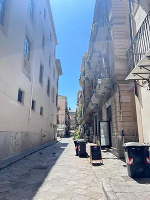 an empty street in an alley between buildings at Dimora dell'Olivella 1 in Palermo
