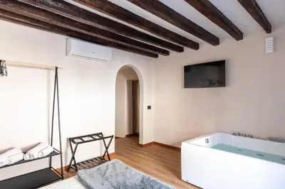 a bedroom with a white bed with two night stands at Vittorio Emanuele Suites&Apartments in Palermo