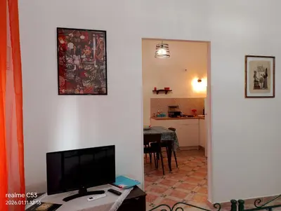 a living room with a flat screen tv and a table at Casa Claudia in Palermo