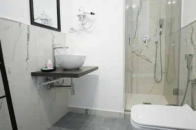 a bathroom with a sink and a shower at Tolo Tolo Apartaments in Palermo
