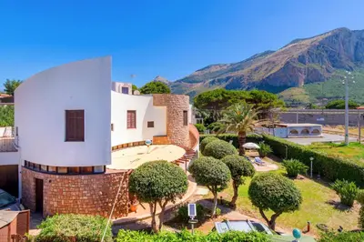 a large white house with a tower at LeSicilien - Tilde Sunset Bay Villa in Carini