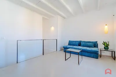a living room with a blue couch and a table at Incantevole Appartamento nel cuore di Palermo in Palermo