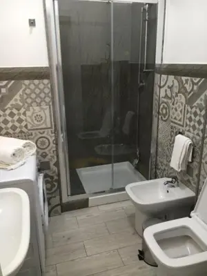 a bathroom with a shower and a sink and a toilet at Le case di Palma in San Vito lo Capo