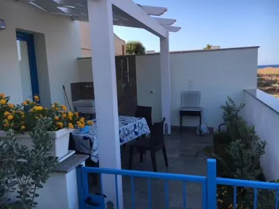 a patio with a table and chairs on a balcony at Le case di Palma in San Vito lo Capo
