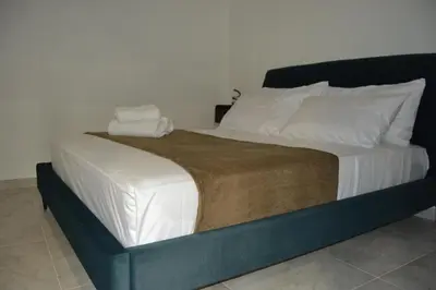 a large bed with two towels on top of it at VitaNova Apartment in Palermo