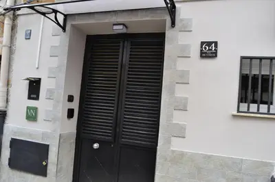 a black door on the side of a building at VitaNova Apartment in Palermo