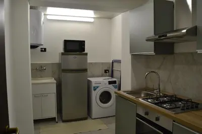 a kitchen with a washing machine and a washer at VitaNova Apartment in Palermo