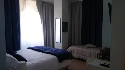 a small bedroom with a bed and a window at B&b Bagheria in Bagheria