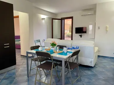 a living room with a table and a couch at Casa Sterlizia by Holiday World in San Vito lo Capo