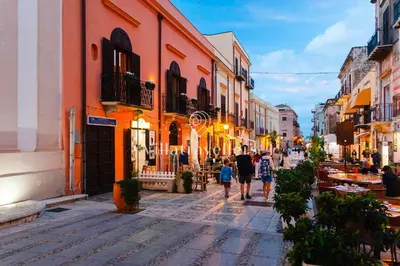 a group of people walking down a street at Elegante palazzo storico con splendida vista mare in Castellammare del Golfo