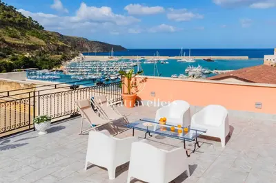 a balcony with a view of a marina at Elegante palazzo storico con splendida vista mare in Castellammare del Golfo