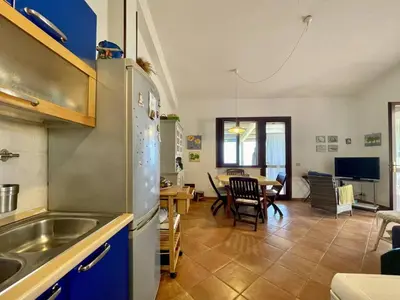 a kitchen with a refrigerator and a dining room at Villa Dorotea in Castellammare del Golfo