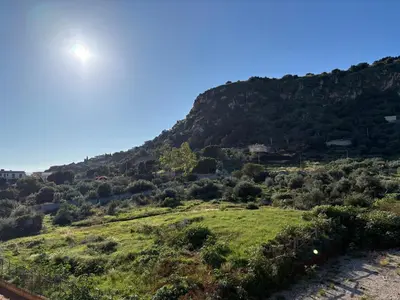 a view of a mountain with the sun in the sky at Le Case di Zefiro in Santa Flavia
