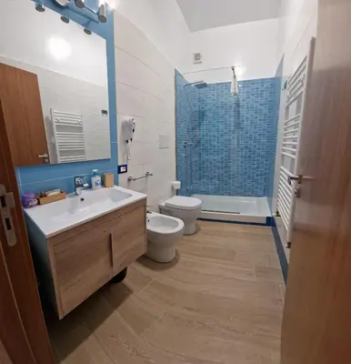 a bathroom with a sink and a toilet and a shower at Casa Fortuna Mondello in Palermo