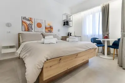 a bedroom with a large bed and a desk at Case libertà in Palermo
