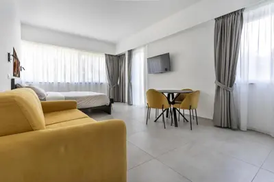 a hotel room with a couch and a bed and a table at Case libertà in Palermo