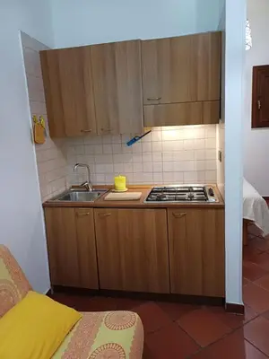 a small kitchen with a sink and a stove at Marku's House in Palermo