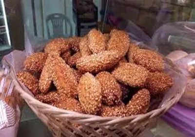 a pile of donuts in a basket on a table at Marku's House in Palermo