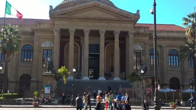 a large building with people walking in front of it at Marku's House in Palermo