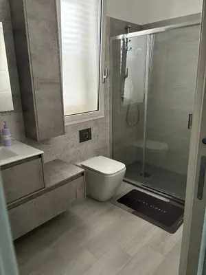 a bathroom with a shower and a toilet and a sink at BALISTRERI HOUSe in Trabia