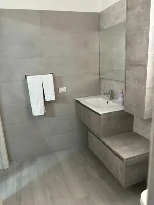 a bathroom with a sink and a mirror at BALISTRERI HOUSe in Trabia