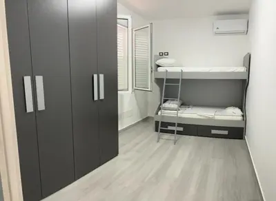 a small room with a bunk bed and a closet at BALISTRERI HOUSe in Trabia