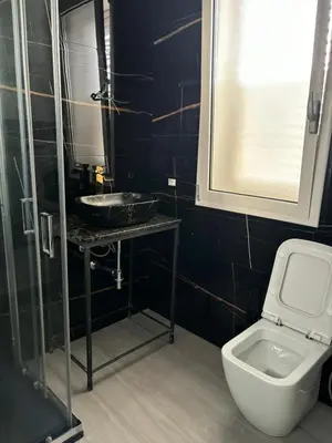 a bathroom with a toilet and a sink and a mirror at BALISTRERI HOUSe in Trabia