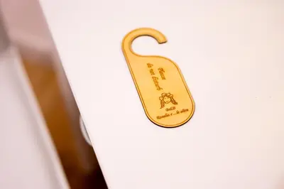 a gold door tag on a white door at Rosalia e le altre in Palermo