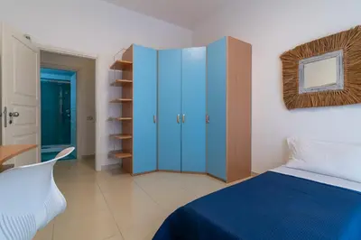 a bedroom with a bed and a blue cabinet at GuestHost - Palermo Roomy and Modern Apartment in Palermo