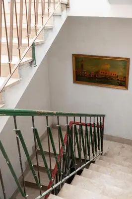 a staircase with a painting of a train on the wall at Terrace in the Sky overlooking Historic Center in Palermo