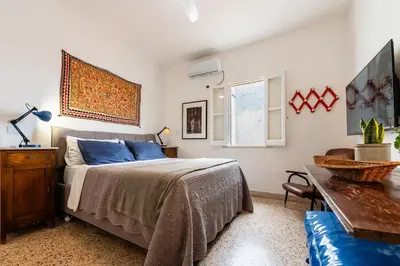 a bedroom with a bed and a table and a couch at Terrace in the Sky overlooking Historic Center in Palermo