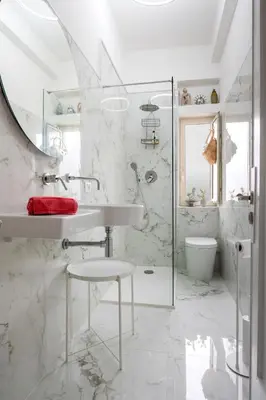 a white bathroom with a sink and a mirror at Terrace in the Sky overlooking Historic Center in Palermo