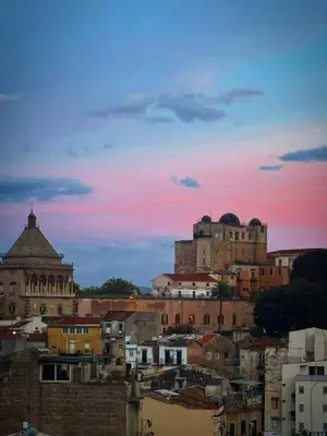 a view of a city skyline with a sunset at Terrace in the Sky overlooking Historic Center in Palermo