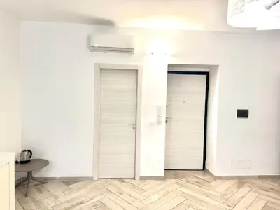 two white doors in a room with a table at Bandiera's House in Palermo