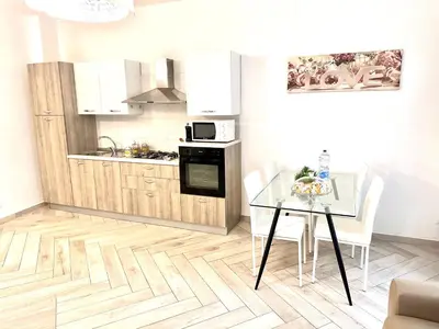 a kitchen and dining room with a table and chairs at Bandiera's House in Palermo