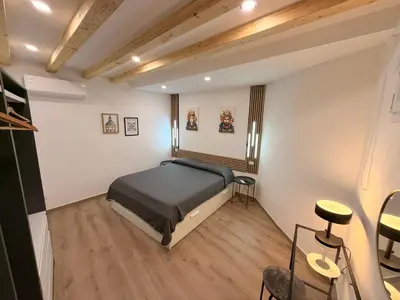 a small bedroom with a bed and a mirror at Dimora Santa Spina - La Corte in Palermo