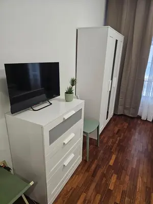 a white dresser with a television on top of it at Court Holiday - La casa del Giudice in Palermo