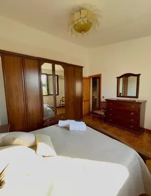 a bedroom with a large bed and a couch at Villa Seaside in Cinisi
