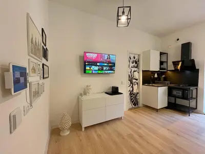 a living room with a flat screen tv on a wall at Oasi urbana Palermo in Palermo