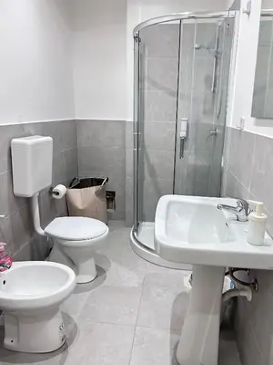 a bathroom with a toilet and a sink and a shower at Dimora dell'Olivella 2 in Palermo
