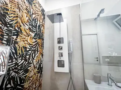 a small room with a bed and a mirror at Daimana holiday apartament in Palermo