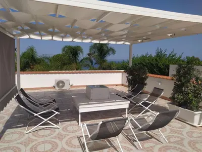 a patio with a table and chairs under a canopy at Holiday Home Casa Gaetano by Interhome in Balestrate