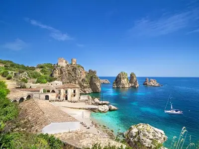 a view of a beach with a boat in the water at Holiday Home Villa Aliotis 200m vom Meer entfernt by Interhome in Alcamo Marina