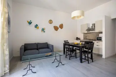 a kitchen and dining room with a table and a couch at Casa Bellini - Centro Storico in Palermo