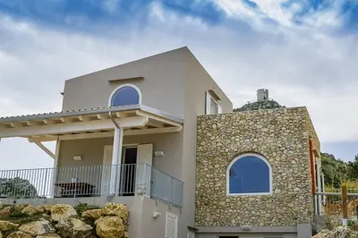 a house with a stone wall at APT Marta in Villa Rosaria Vista Mare Zingaro in Scopello