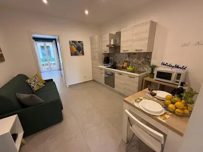 a kitchen and living room with a couch and a table at palermo house in Palermo