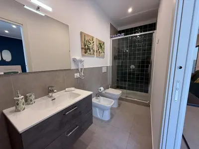 a bathroom with a sink and a toilet and a mirror at palermo house in Palermo