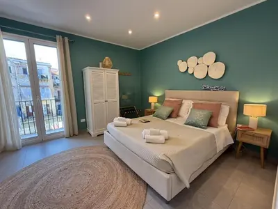 a bedroom with a large bed with towels on it at palermo house in Palermo